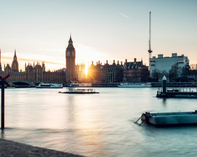 the sun is setting over the city of london