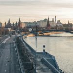 a view of a bridge over a river with a city in the background