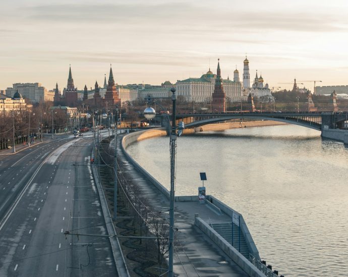 a view of a bridge over a river with a city in the background