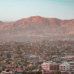 a view of a city with mountains in the background