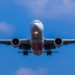 white and blue airplane under blue sky during daytime