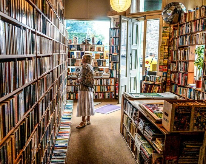 woman inside library looking at books