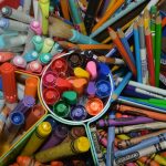 a group of colored pencils