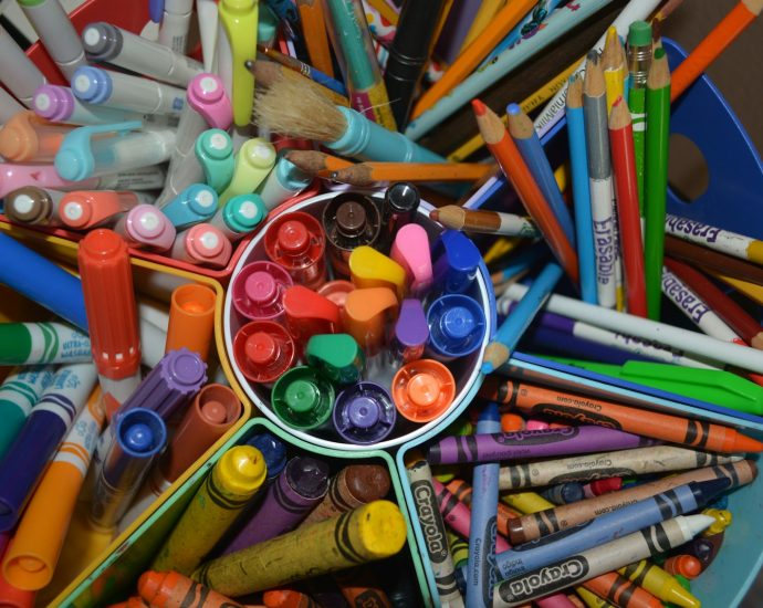 a group of colored pencils