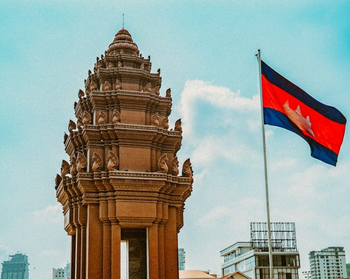 brown concrete building with flag of us a during daytime