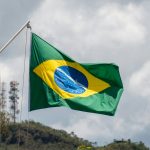 a green and yellow flag flying in the wind