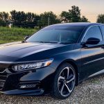 a black car parked on a gravel road