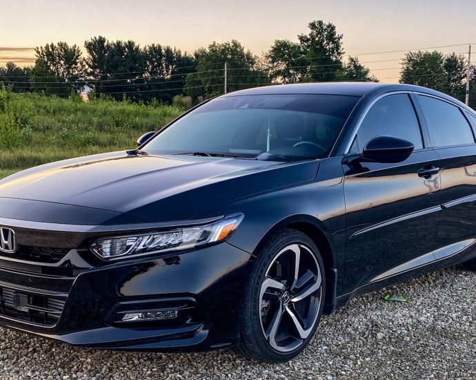 a black car parked on a gravel road