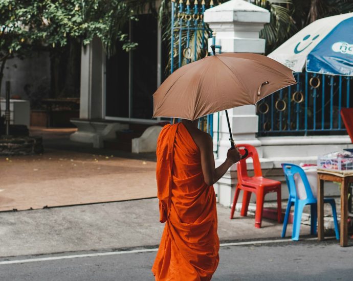 a person walking down a street holding an umbrella