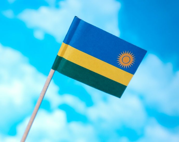 a small flag flying in the wind on a sunny day