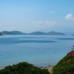 a body of water with hills in the background