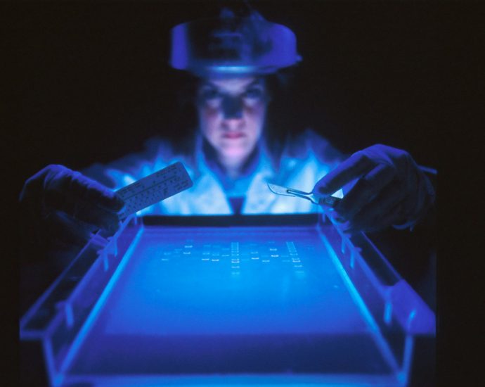woman doing research while holding equipment