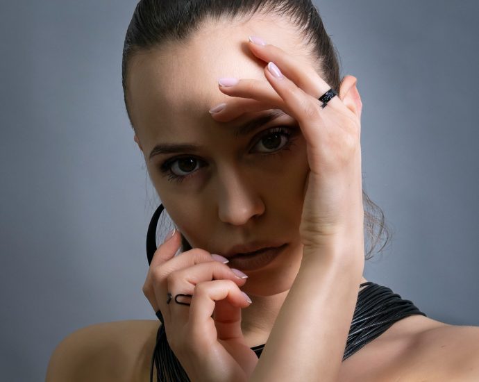 A woman is striking a pose, looking at the camera.