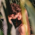 man and woman standing and about to kiss on lips