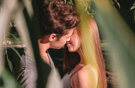 man and woman standing and about to kiss on lips