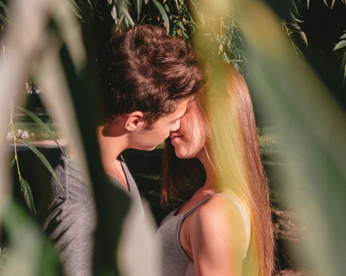man and woman standing and about to kiss on lips