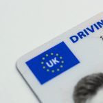 Detailed photo of a UK driving license showcasing EU flag and identity features.