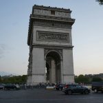 a group of cars parked in front of a monument