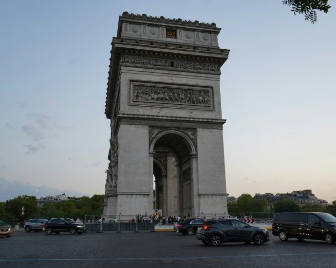 a group of cars parked in front of a monument