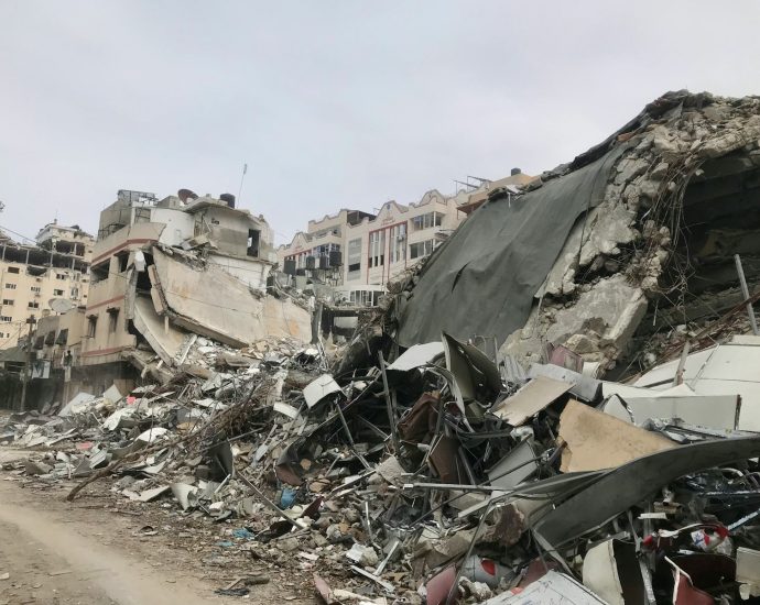 a large pile of rubble next to a dirt road