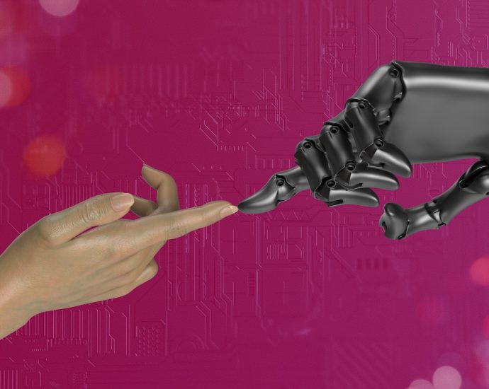 two hands touching each other in front of a pink background