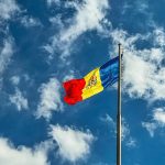 red blue and yellow flag under blue sky during daytime