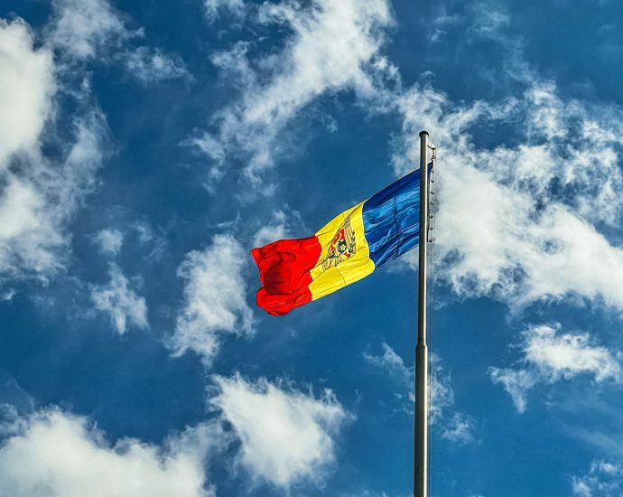 red blue and yellow flag under blue sky during daytime
