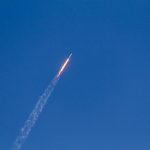 flying rocket during daytime