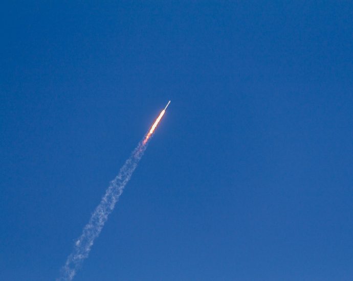 flying rocket during daytime