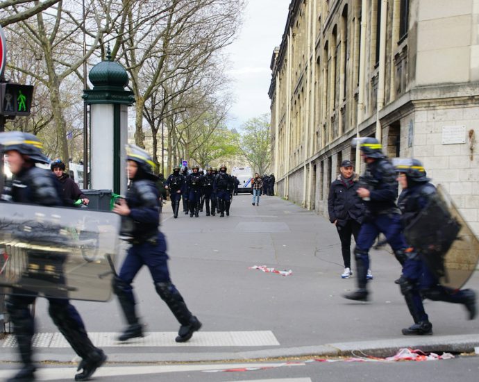 a group of police running across a street