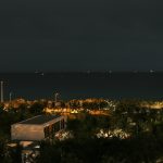 Distant lights on the ocean at night.