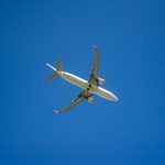 a large passenger jet flying through a blue sky
