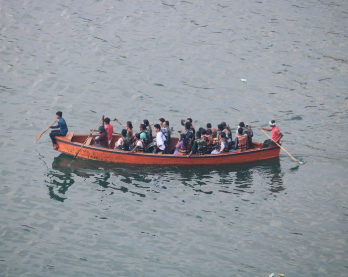 People are riding in a boat on the water.