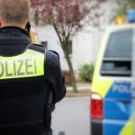 a police officer standing in front of a police car