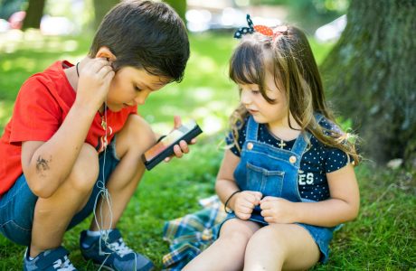 girl in blue denim button up vest holding smartphone