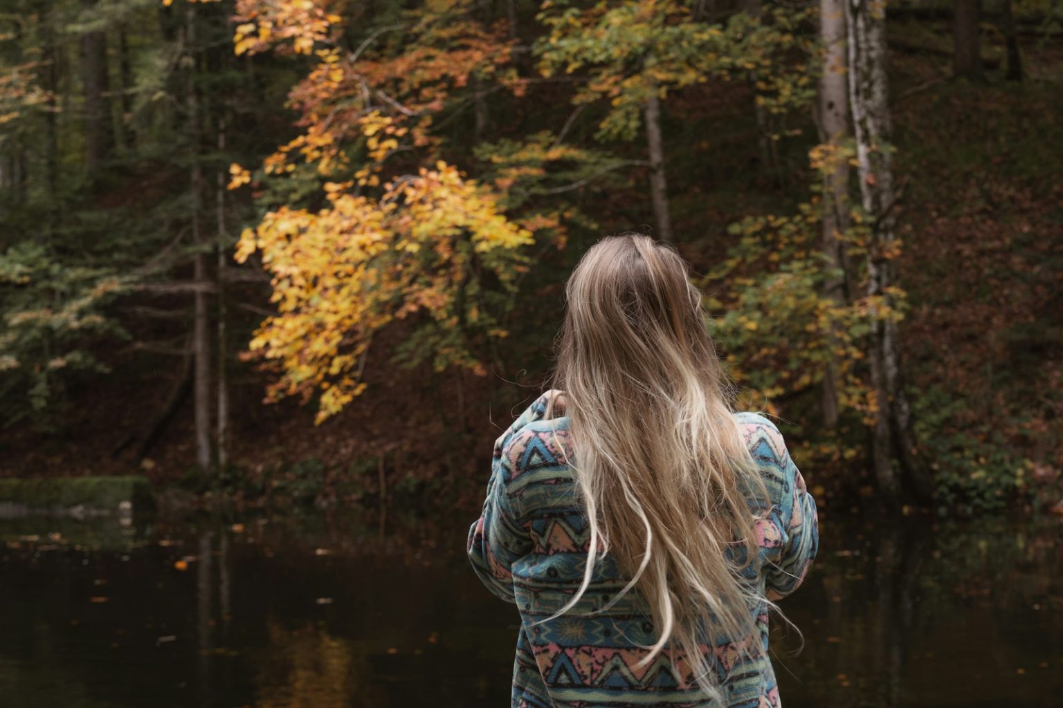 A woman standing in front of a body of water