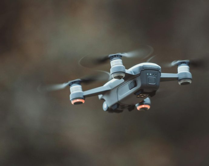 A detailed close-up of a drone flying in an outdoor setting, showcasing its design and technology.