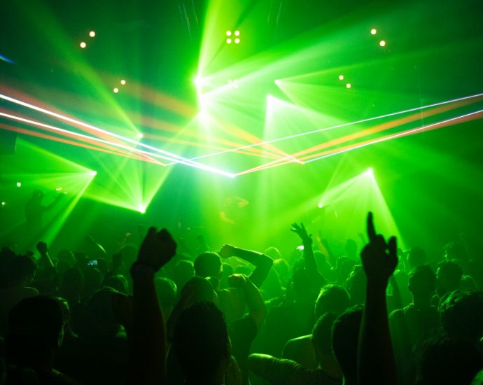 people dancing inside room with green lights