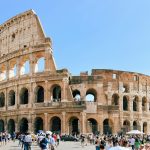 a group of people standing in front of an old building