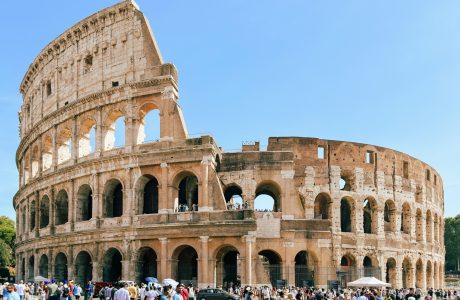 a group of people standing in front of an old building