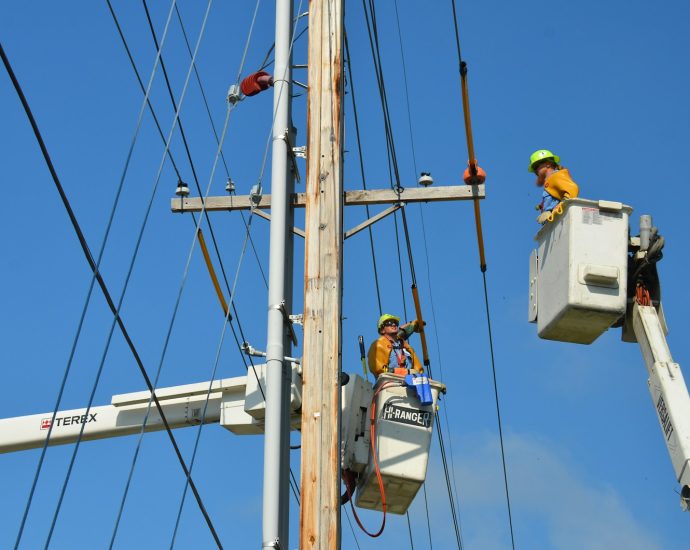 two linemen on cherry pickers