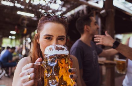 woman in black long sleeve shirt holding drinking glass