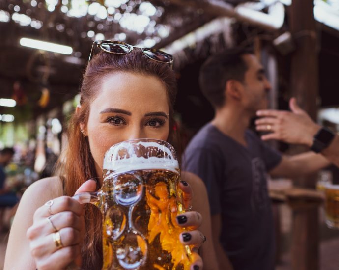 woman in black long sleeve shirt holding drinking glass