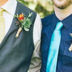 men wearing ties and flower jewelries