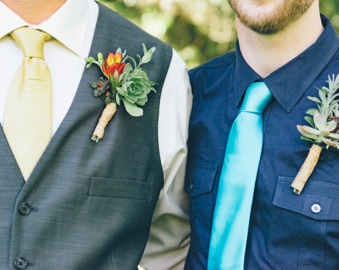 men wearing ties and flower jewelries