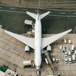 white and blue airplane on airport during daytime