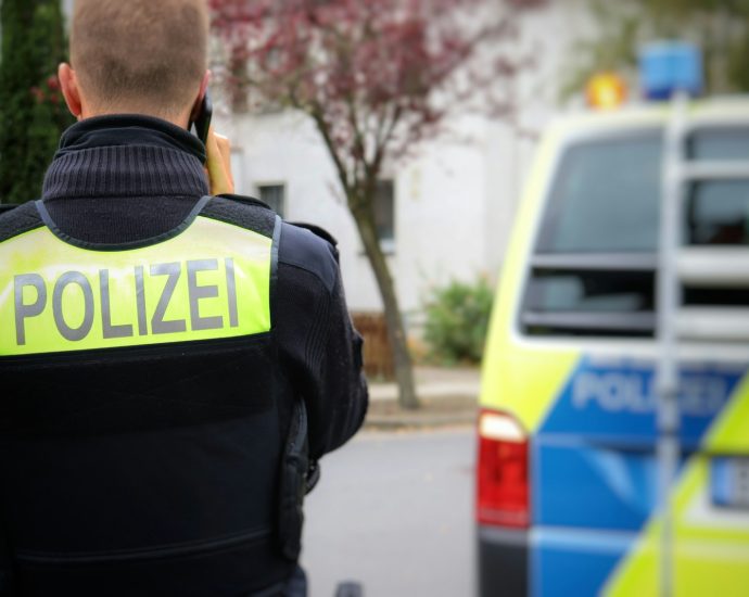 a police officer standing in front of a police car