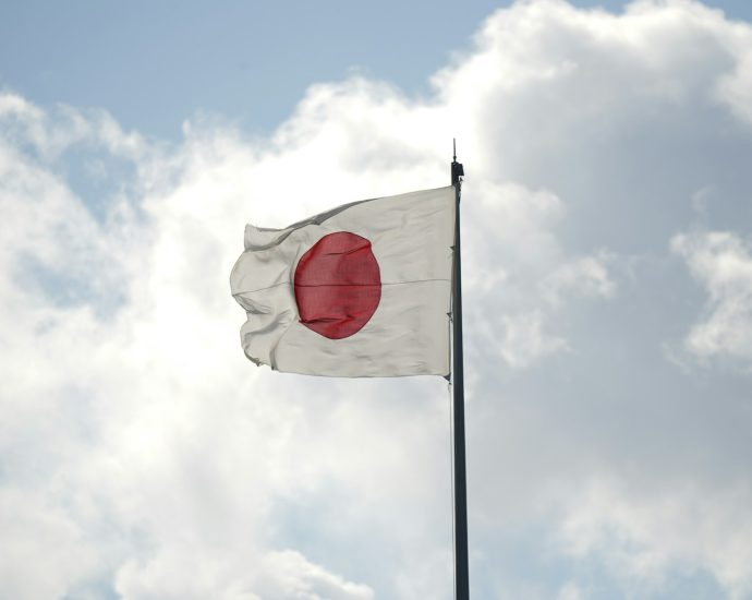 a white and red flag flying in the sky