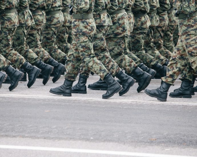 men in green and brown camouflage uniform