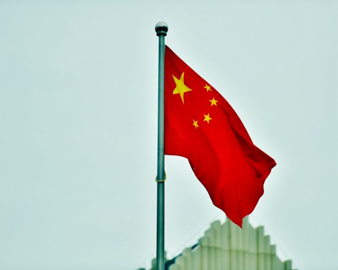 a red and yellow flag on a pole